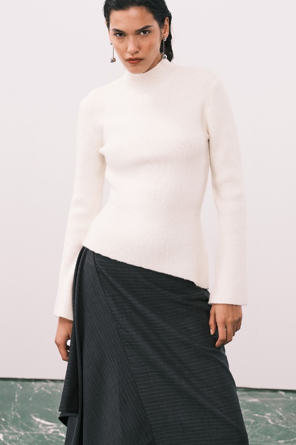 Ribbed Knit Roll Neck Asymmetric Hem Top from Pretty Lavish